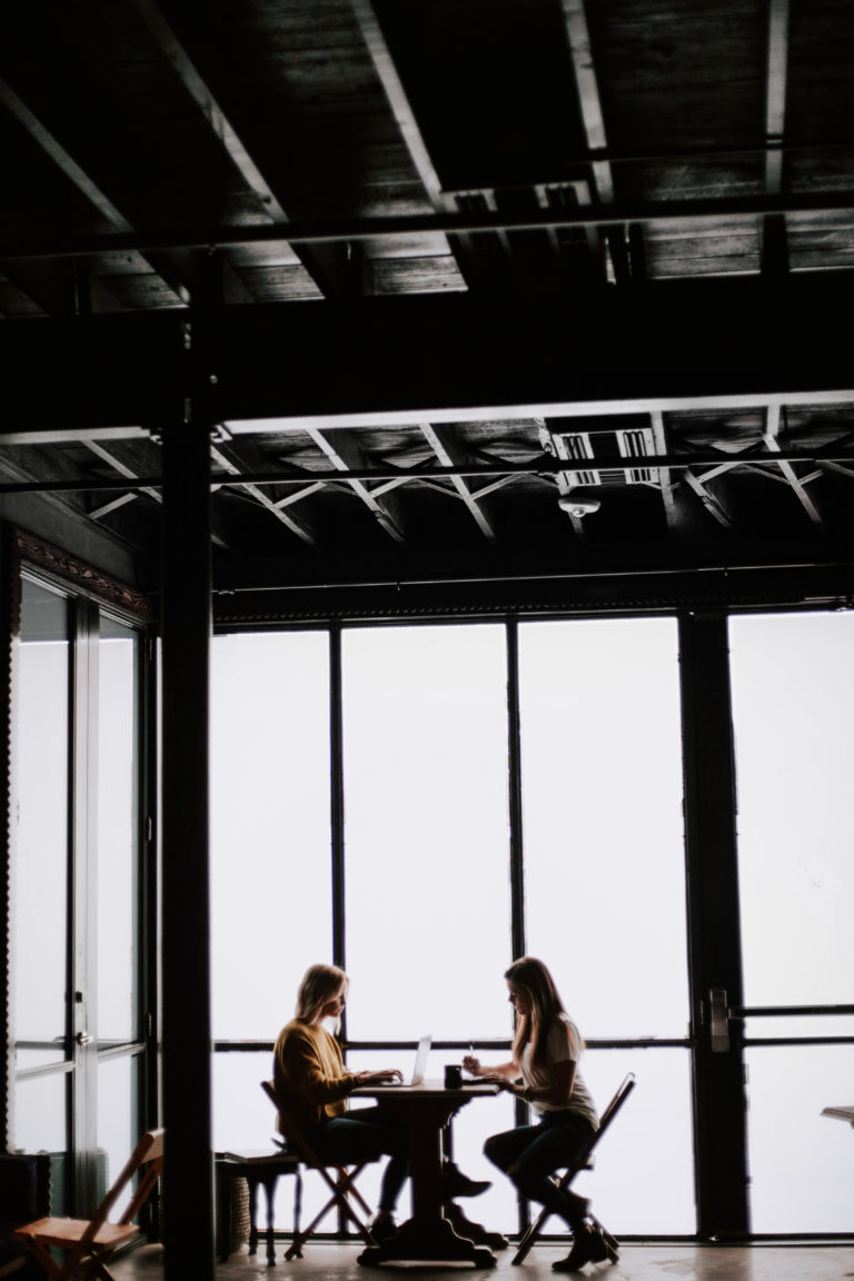 two female workers in a large office space